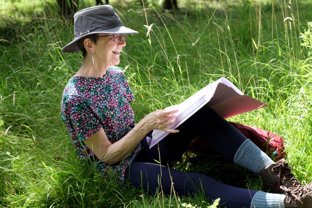 Judith Morris in nature writing her memoir, Stepping out of Silence